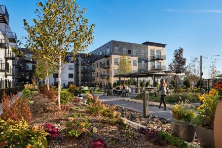 An exterior view of The Collection, a six-level, mixed-use building featuring 230 apartments and more than 50,000 square feet of retail and grocery space that earned the LEED v4 BD+C Gold certification January 2024. 